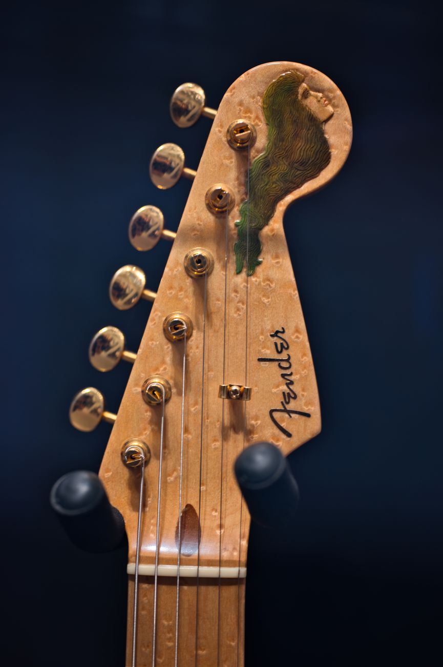 Detailed view of a Fender guitar headstock on display in Tokyo, Japan.